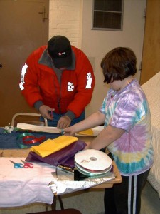 One of the Dad's helping his daughter wrap the gift she made.